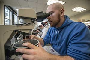 Students posing outside natural science building